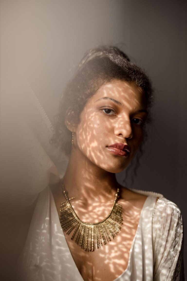 Stylish portrait of a woman with creative lighting casting artistic shadows on her face.fashion jewellery shop